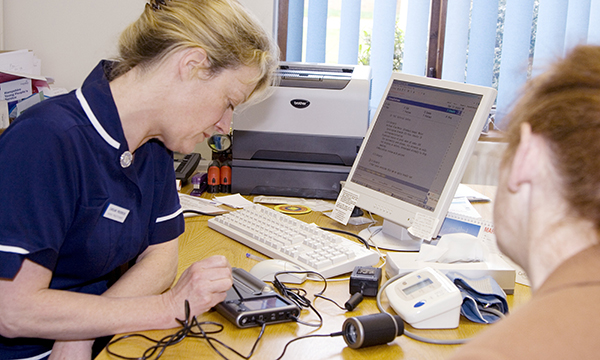 Image shows a general practice nurse with a patient