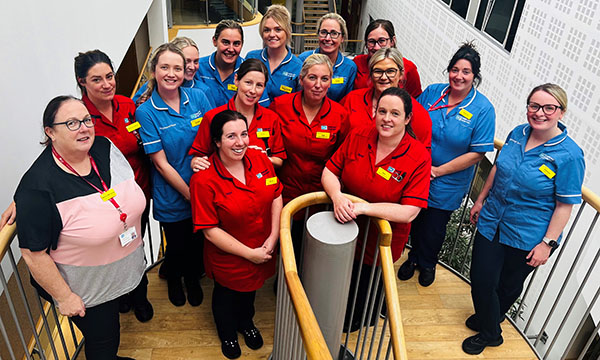 Patient’s Choice award winners the Arches District Nursing Team standing together on a staircase landing at their workpalce
