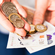 A selection of British coins with a £10 and £20 note