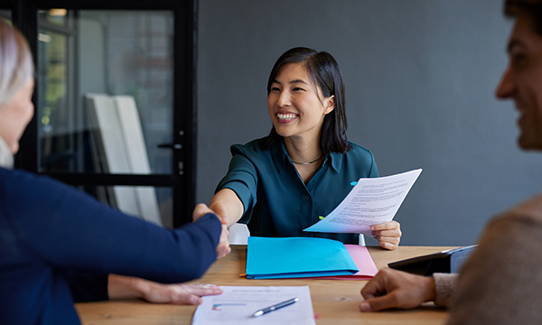 A nursing job interview with smiling candidate and interviewers