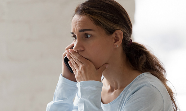 Picture shows a woman looking anxious and speaking on a&nbsp;phone. Two&nbsp;mental health trusts in London have set up round the clock mental health emergency departments that patients in crisis can reach by phone during the pandemic.