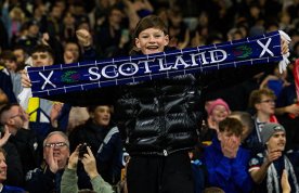 Young boy in crowd of Scottish football supporters – nurses in Scotland's NHS to be included in bank holiday to celebrate men's football world cup 