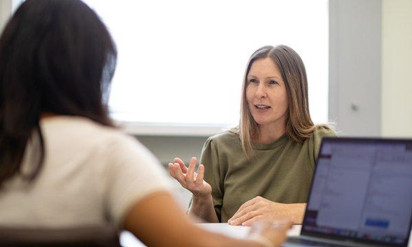 A confident-looking senior nurse being interviewed by a potential employer
