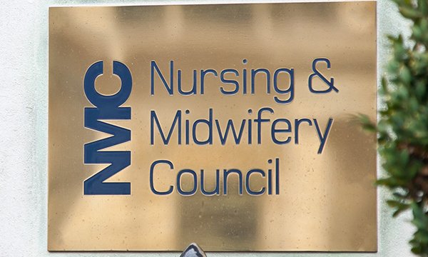 Brass name plate at entrance to NMC building