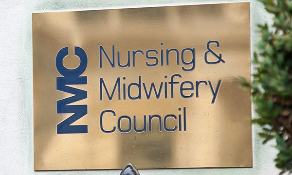 Brass name plaque at the entrance of the NMC building 