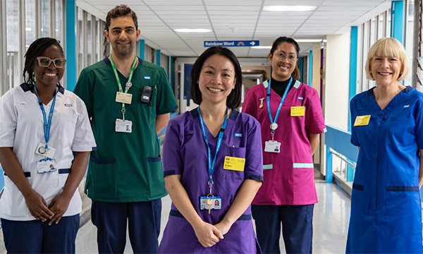 Nurses and allied health professionals wearing the new standard NHS uniform, which offer dress as well as scrubs option