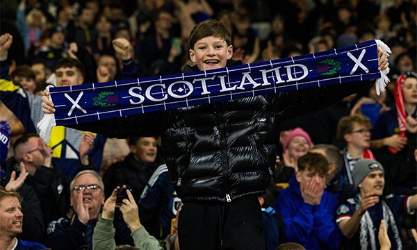 Young boy in crowd of Scottish football supporters – nurses in Scotland's NHS to be included in bank holiday to celebrate men's football world cup 