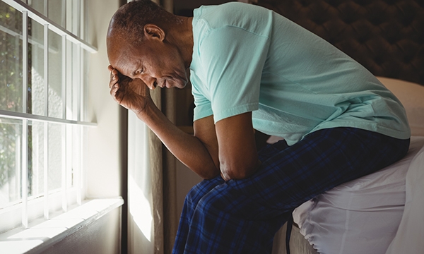 man sits on bed