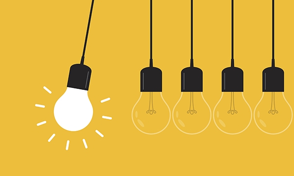 Several lightbulbs, one illuminated