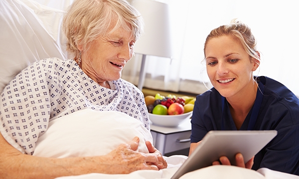 nurse and patient view laptop